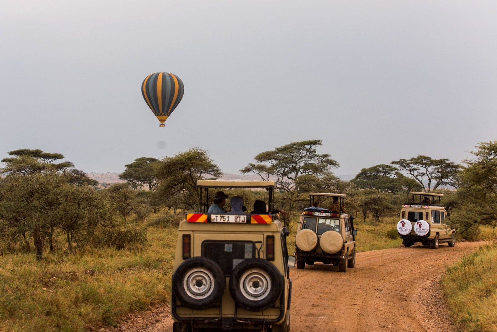 Scenic safari adventure in Tarangire with off-road vehicles and a hot air balloon in the savannah.