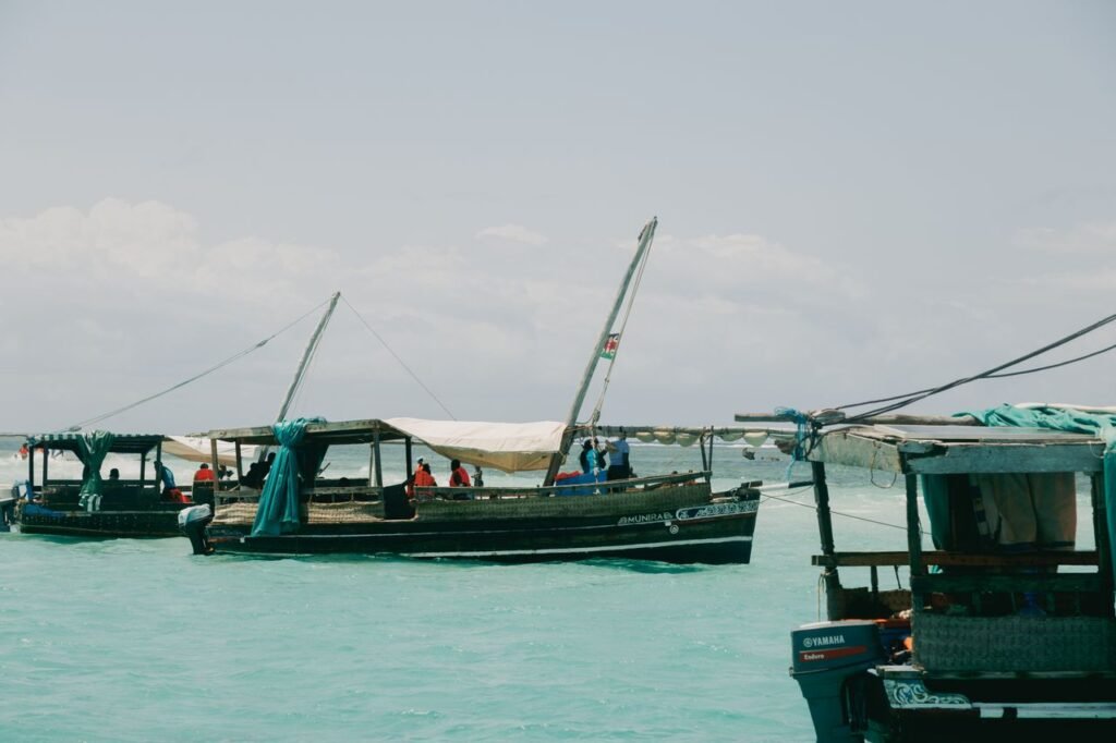 Traditional fishing boats in Mombasa harbor on a sunny day, showcasing local culture.
