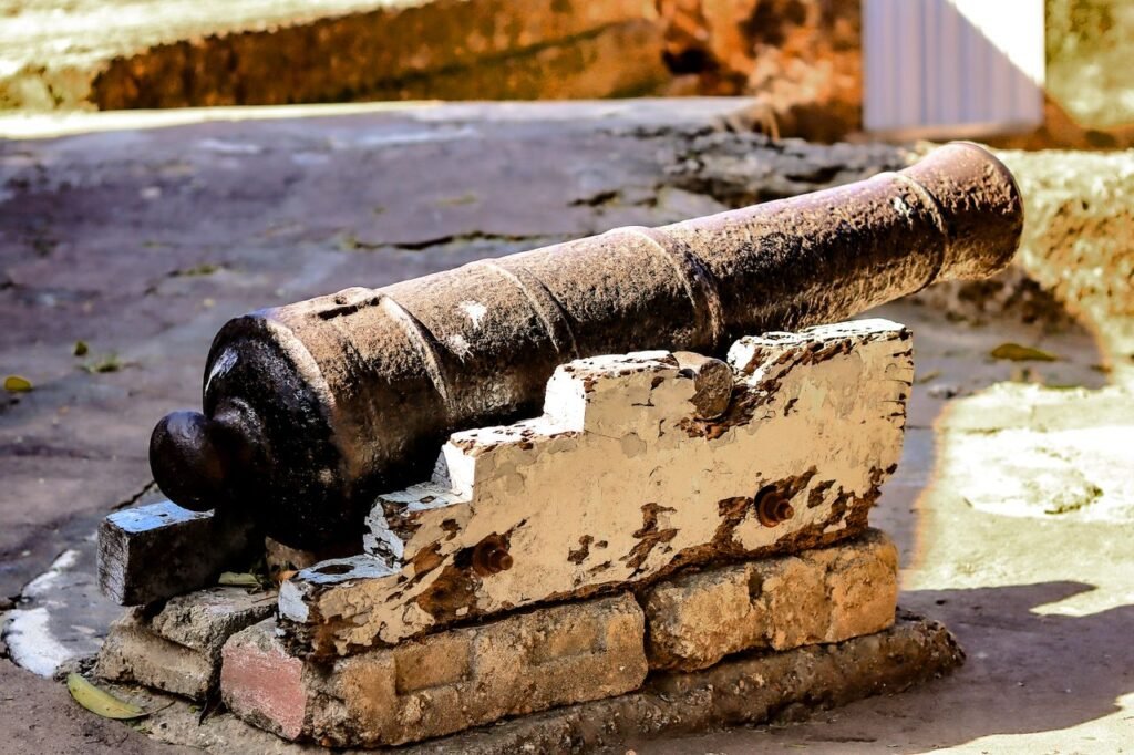 A weathered antique cannon displayed at historic Fort Jesus in Mombasa, Kenya.