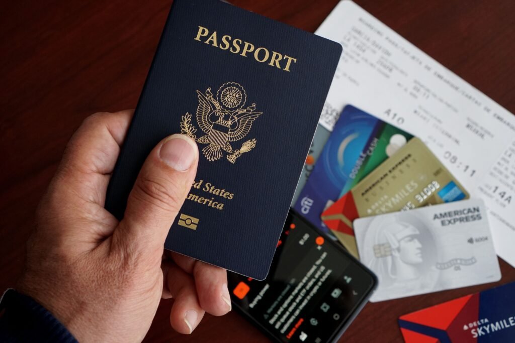 Best Time to Visit Kenya for Safari in 2026 – Complete Travel Guide A close-up of a US passport with credit cards, tickets, and a mobile phone on a table.
