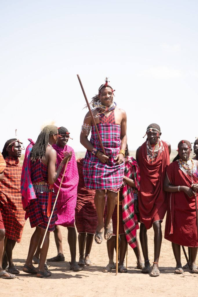 A vibrant Maasai tribe performing a traditional dance in Kenya's outdoors.