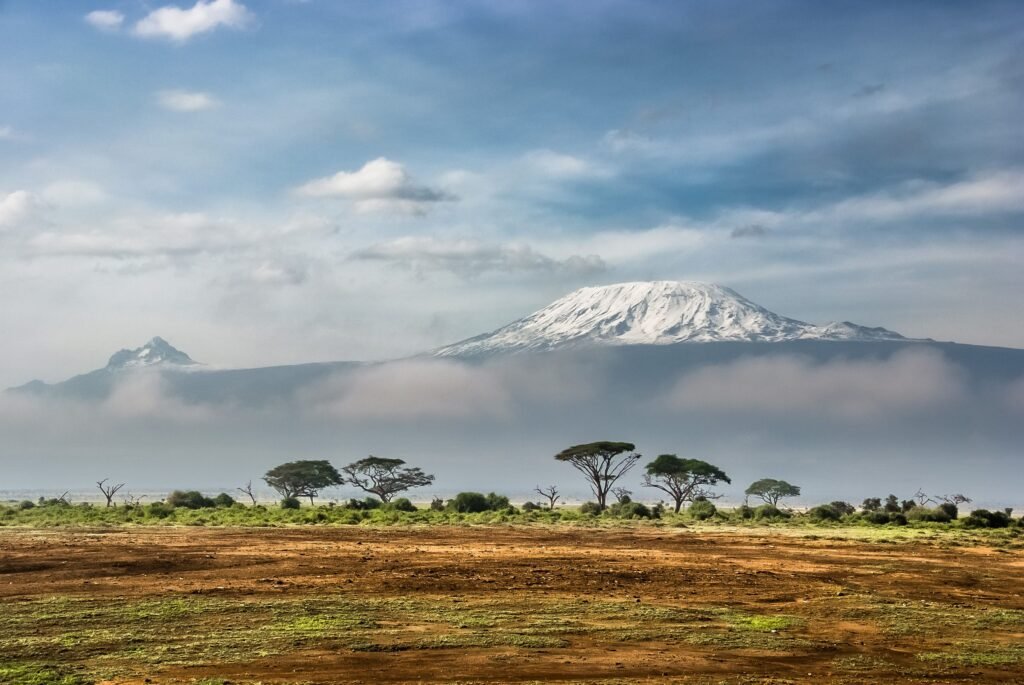 Breathtaking view of snow-capped Mount Kilimanjaro with surrounding African savannah.